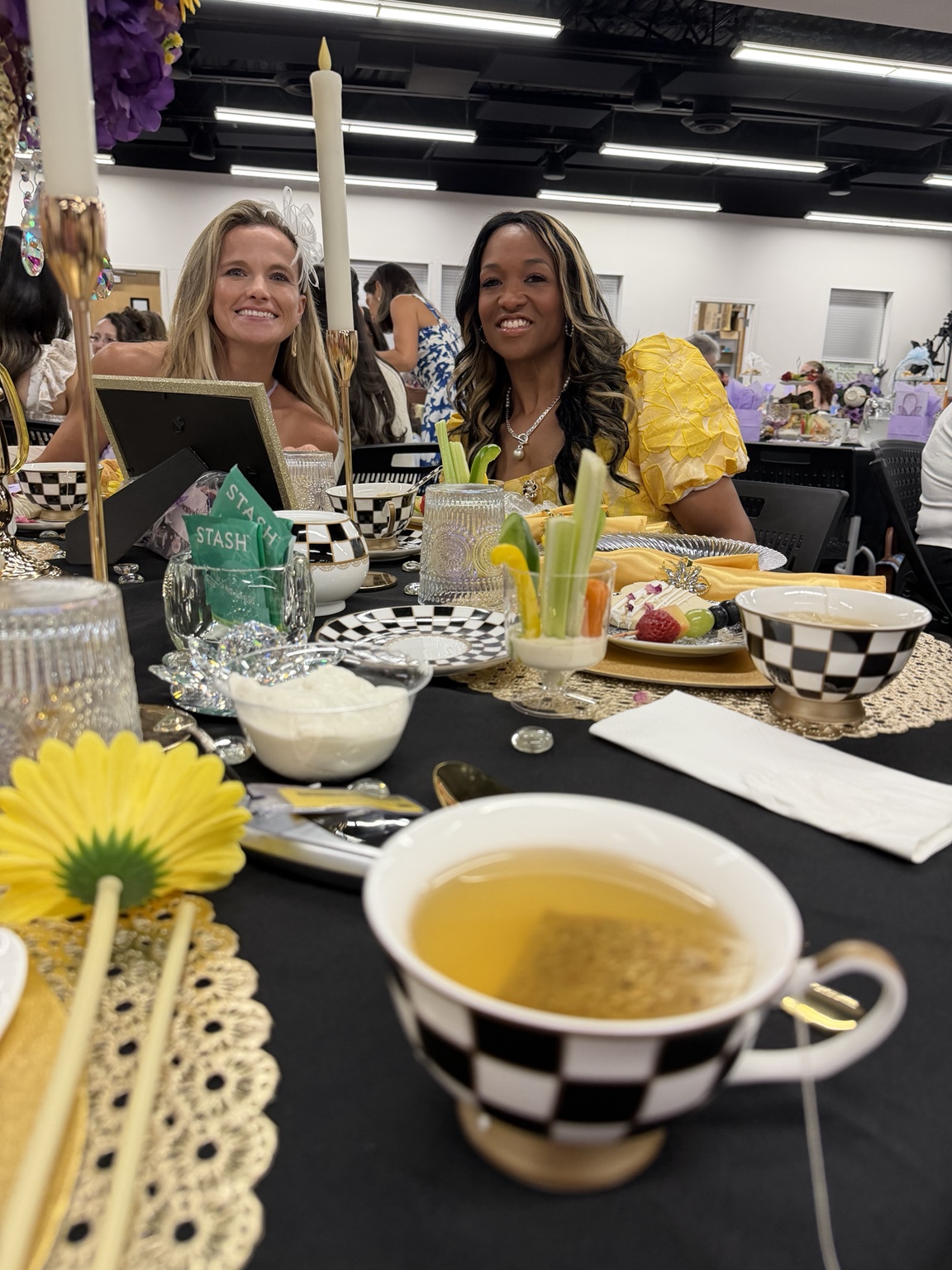 Takara Fuller-Doby seated with a guest at the Hope for Her Panty Tea Party